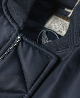 Navy zippered chest pocket and ribbed knit crew neckline detail