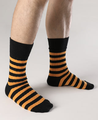 Black and orange striped cotton socks with ribbed ankle cuffs.