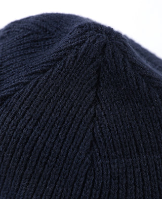 Navy knit watch cap beanie close-up of ribbed crown texture