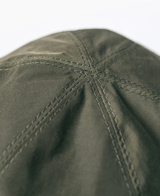 Olive nylon cap crown close-up with reinforced seam stitching