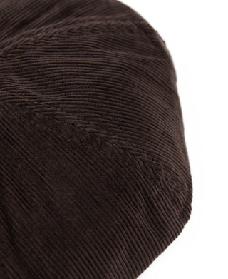 Dark brown corduroy cap close-up showing fine ribbed fabric texture