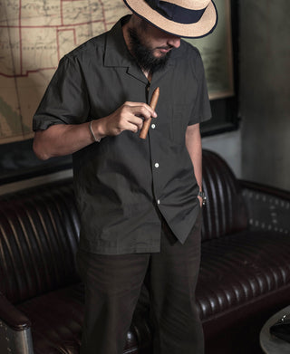 Dark gray open-collar short-sleeve button shirt with chest pocket detail
