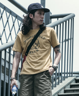 Navy 5-panel cotton cap worn on a person with a curved brim and front logo patch