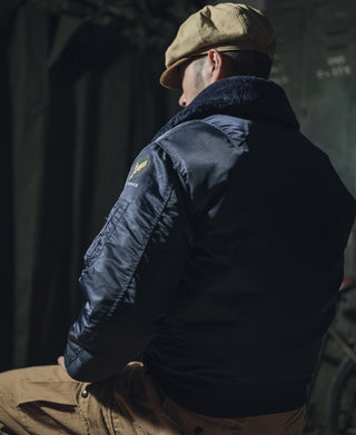 Navy B-15C flight jacket on model, back/side view with shearling-style collar