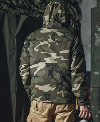 Woodland camo parka back view with hood and vented hem.