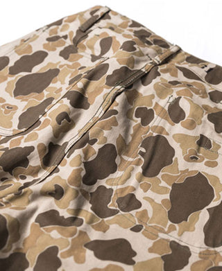 Duck hunter camo pants with buttoned fly and zipper front, close-up of fabric.
