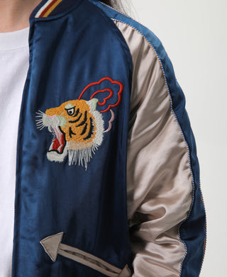 Blue reversible acetate souvenir jacket sleeve detail, embroidered tiger patch with ribbed cuff trim
