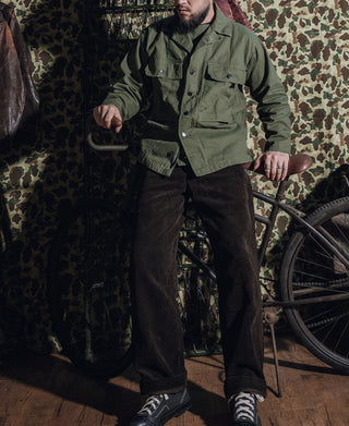 Olive green HBT jacket worn with button front and two chest flap pockets