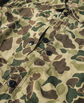 Camouflage jacket front placket with snap buttons and visible stitching