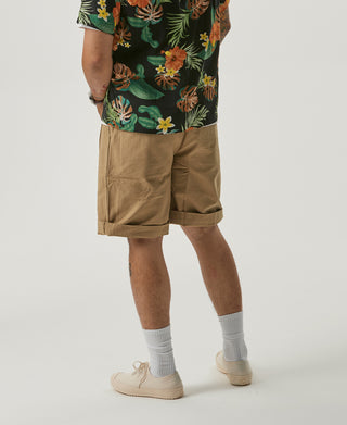 Khaki bermuda shorts on model with flap pocket detail and cuffed hem