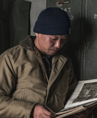 Navy knit watch cap beanie with folded cuff and ribbed texture