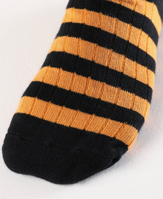 Black and orange striped knit sock with ribbed cuff and rounded toe.