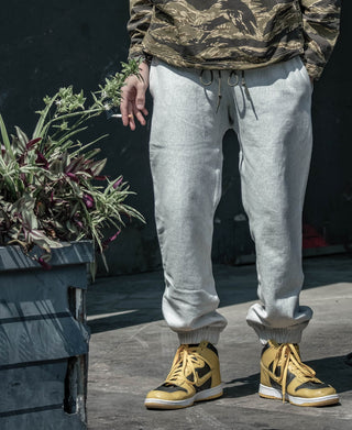 Light gray sweatpants with drawstring waist and tapered jogger fit