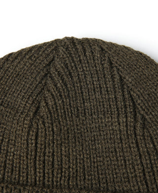 Olive knit watch cap close-up of textured ribbing on crown