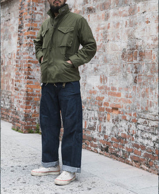 Dark navy denim pants with straight leg silhouette and cuffed hem