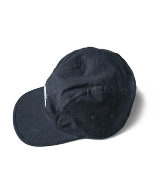 Dark navy 5-panel cap with curved brim and subtle stitched texture, logo on front