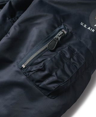 Navy jacket pocket with stitched flap, metal zipper, and small U.S. AIR marking