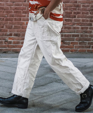 White herringbone deck pants, full-length view with pleated front and side pockets