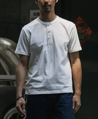 White cotton henley T-shirt on a man, short sleeves and buttoned neckline placket