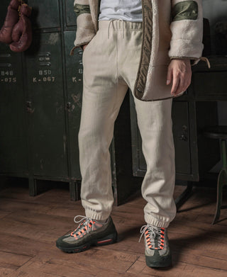 Light cream terry sweatpants standing; elastic waistband and cuff details