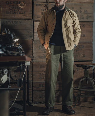 Navy crewneck wool sweater worn under outerwear, ribbed collar and cuffs
