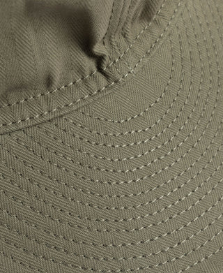 Olive A-3 flight cap brim close-up with curved stitching rows