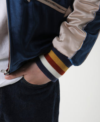 Blue reversible acetate souvenir jacket detail, ribbed hem with multicolor striped trim