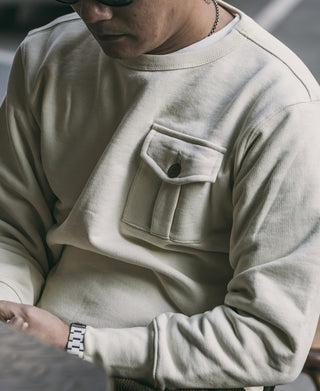 Apricot crewneck sweatshirt with square chest pocket and buttoned flap detail