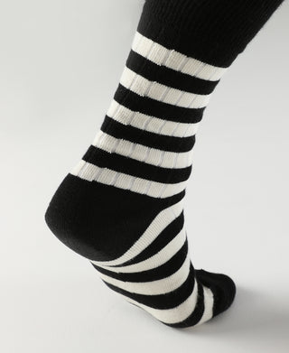 Black and white striped crew cotton socks, angled view of toe and striped leg