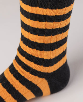 Close-up of orange-and-black striped sock with ribbed knit texture.
