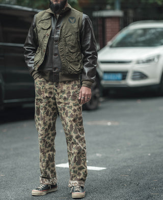 Reversible camo pants worn by a person, full length view in green tan pattern