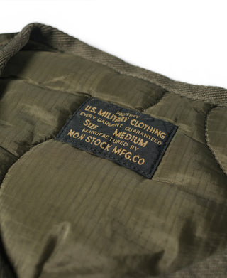 Olive nylon vest interior label on quilted padded fabric