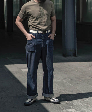 Dark navy denim pants with relaxed straight legs, belt loops, and five-pocket design
