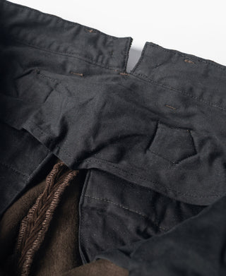 Brown corduroy pants waistband with buttoned fly and pleated front
