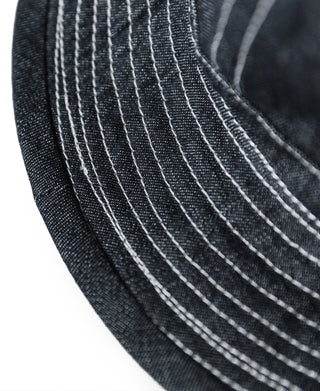Indigo denim bucket hat brim close-up with white stitched radial lines