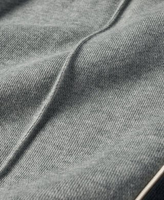 Gray cotton-terry sweatpants fabric with seam detail close-up