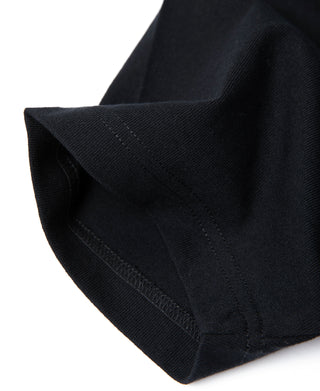 Black cotton tubular T-shirt, ribbed sleeve cuff with visible seam stitching