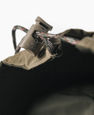 Olive nylon cap toggle closure with black inner lining detail