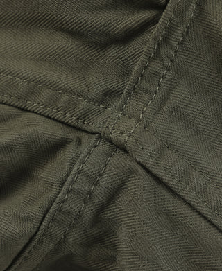 Close-up of olive utility shorts seam stitching and fabric grain
