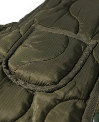 Olive quilted padded vest with stitched flap pockets and textured rib trim