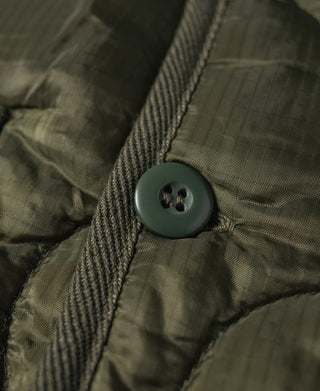 Olive jacket snap button on pocket flap with quilted texture
